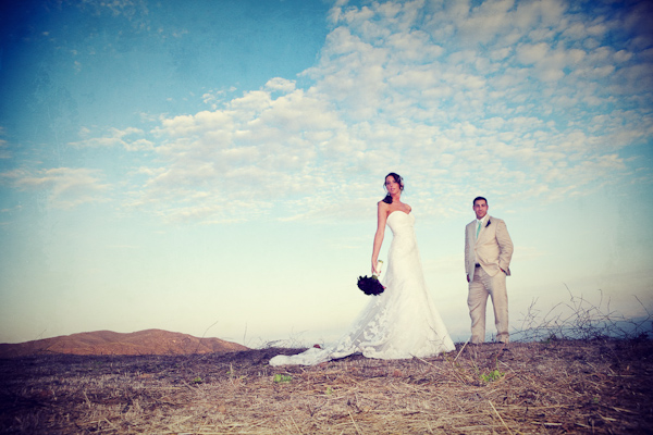 the happy couple posing on top of a knoll with a view - photo by Southern California wedding photographers Callaway Gable